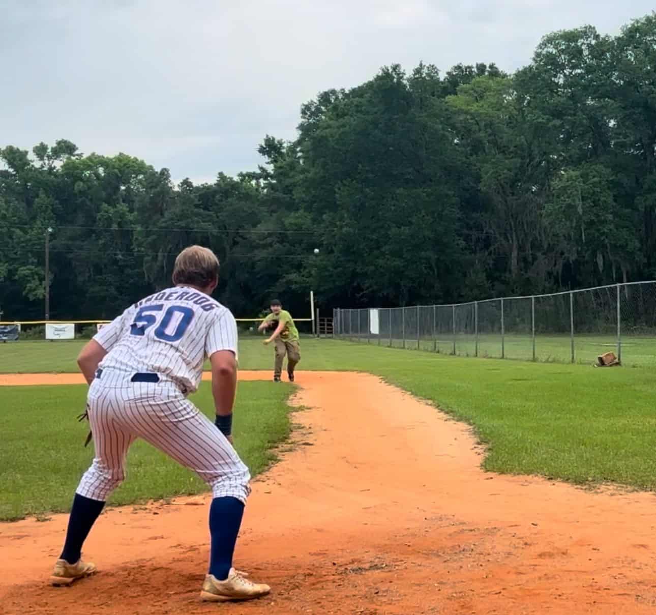 Playful baseball game at local field with kids and coaches, outdoor sports activity, youth baseball practice.
