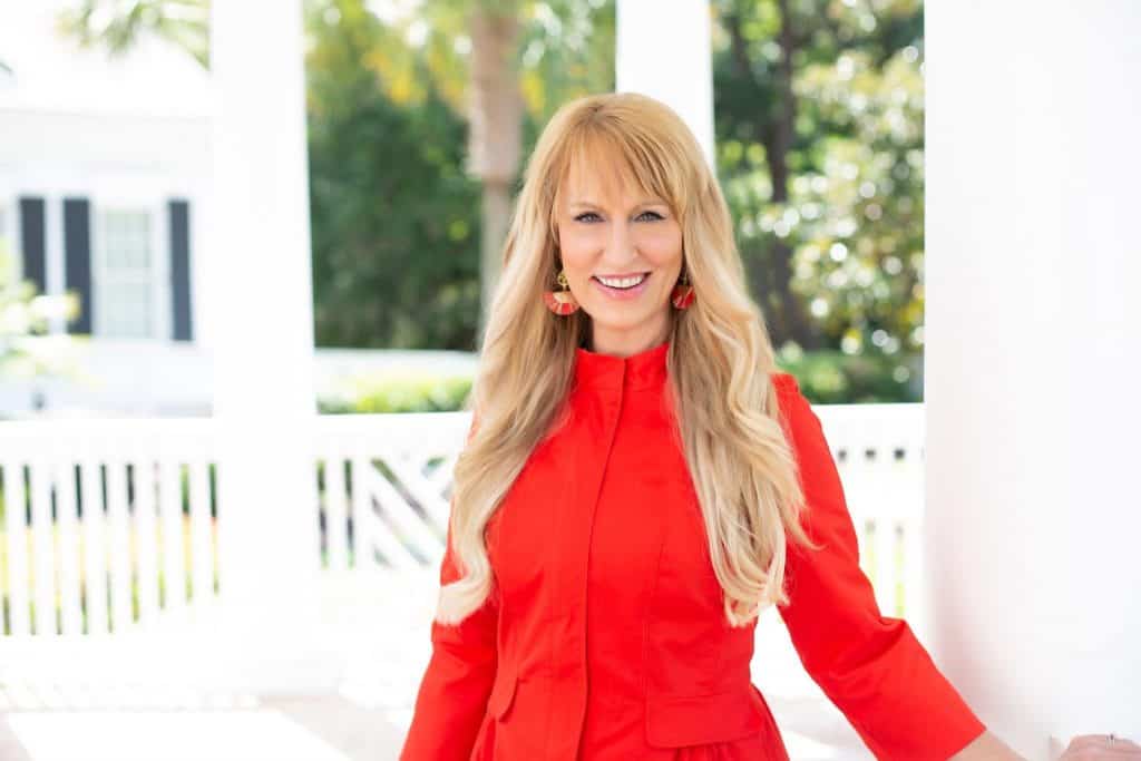 Confident woman smiling outdoors, promoting businesses for liberty and entrepreneurial freedom.
